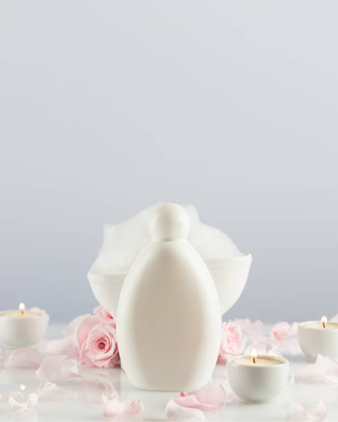 istock Spa composition with white cosmetic bottle, soap foam and candles 1453813469