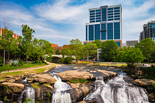 Greenville, South Carolina USA - May 4, 2022: Downtown cityscape view of the popular Falls Park on the Reedy in this charming southern town.