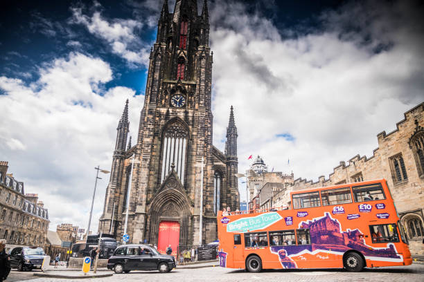 Edinburgh, Scotland - July 14, 2022:  A tourbus is passing by the Tolbooth Kirk (church) on Castle Hill in Edinburgh Old Town.
