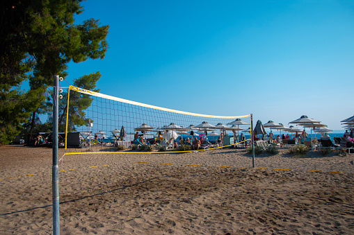 Nikiti, Greece, Lagomandra Beach - 07/31/ 2022. Volleyball net on sand in summer background. Outdoor leisure games. Active lifestyle on beach with sand near sea or ocean with sky.