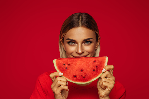 Portrait of girl holding slice of watermelon