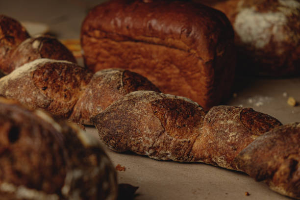 istock Baguette and different types of sourdough kraft bread on kraft paper background 1453821892