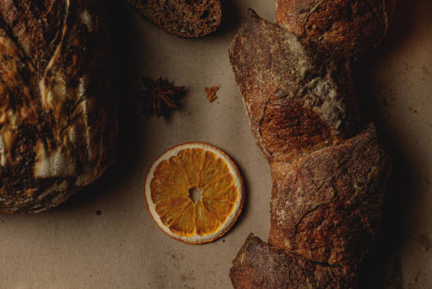 istock Baguette and different types of sourdough kraft bread on kraft paper background 1453821893