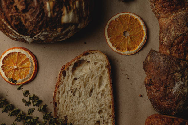 istock Baguette and different types of sourdough kraft bread on kraft paper background 1453821898