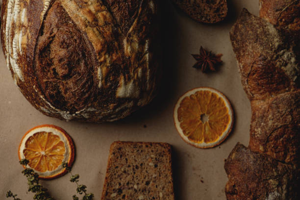 istock Baguette and different types of sourdough kraft bread on kraft paper background 1453821899