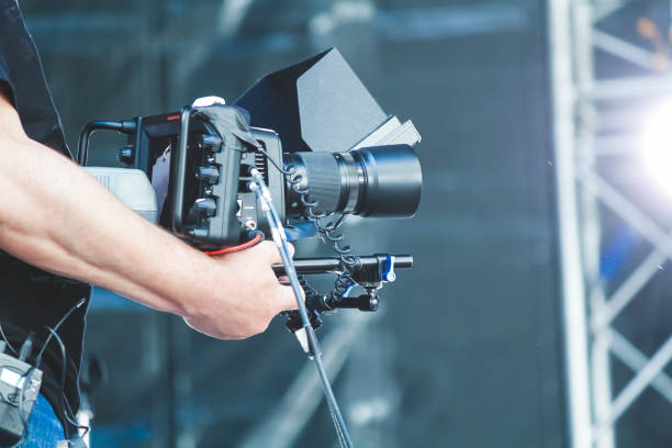 istock The operator with a video camera shoots a concert. Shooting video at the event. 1453822753