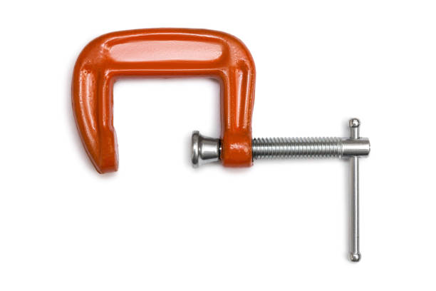istock Orange steel clamp tool isolated on white background 1453824396