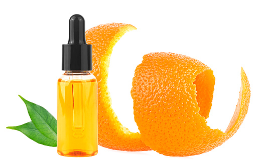 Orange peel and orange essential oil isolated on a white background. Vitamin C serum in cosmetic bottle. Organic SPA cosmetics, natural skin care.