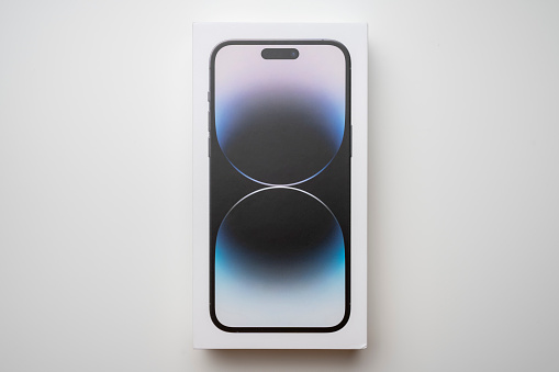 Budapest, Hungary - December 14, 2022. iPhone 14 Pro Max in Space Black color, in box. In Apple's latest phone, the Dynamic Island is an innovation and equipped with three cameras. White background.
