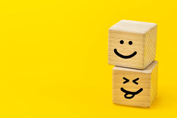 istock positive thinking, creative concept, hand painted facial expression on wooden blocks, yellow background, copy space, smiling faces, self esteem, good emotions 1453827228