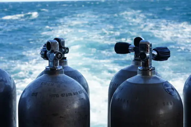 a close up shot of Scuba diving tank and the water as a background.