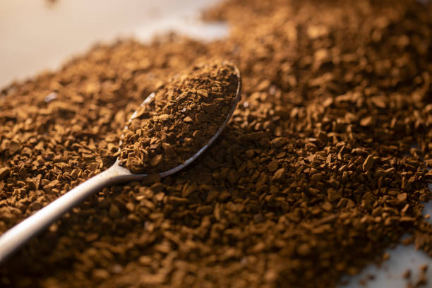 Instant Coffee granules in a spoon Instant Coffee granules shot in soft beautiful lighting with a silver teaspoon instant coffee stock pictures, royalty-free photos & images