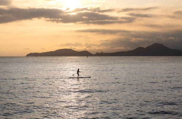 istock Girl practicing stand up paddle during the late afternoon in Santos bay 1453832979