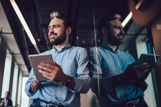 istock Adult elegant man with tablet in office 1453833529