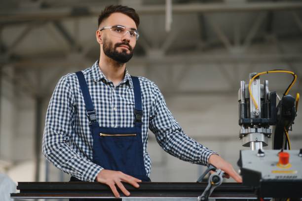 istock Worker in uniform working on machine in PVC shop indoor 1453834211