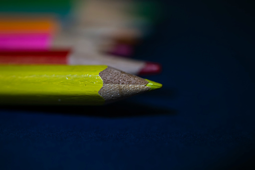 Colouring Pencils arranged on a dark background - Back to school