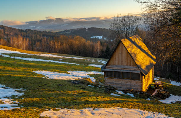 Winter landscape of Moravian-Silesian Beskids mountain range at the east of Czech Republic Winter scenery in silesian beskids with wooden shed by sunset beskid mountains stock pictures, royalty-free photos & images