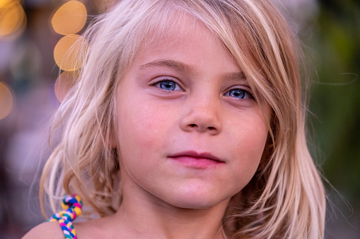 Smiling caucasian little girl looking at the camera, headshot,  child, human eye, blue eyes