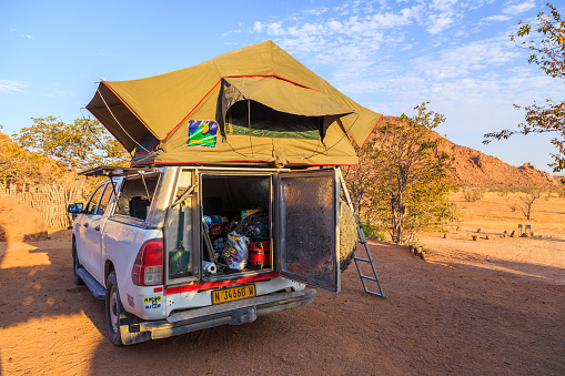 Mowani, Damaraland, Namibia - 04 October 2018: Typical 4x4 rental car in Namibia equipped with camping gear and a roof tent at the campground.