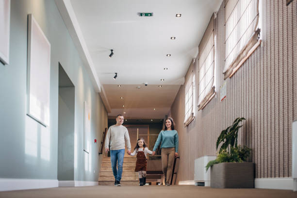 istock Family walking in hotel corridor 1453837250