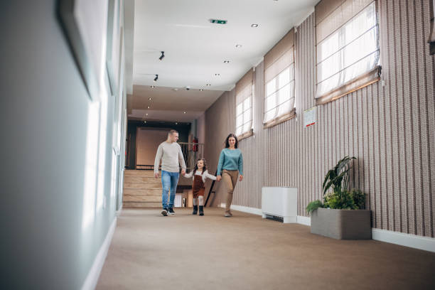 istock Family walking in hotel corridor 1453837263