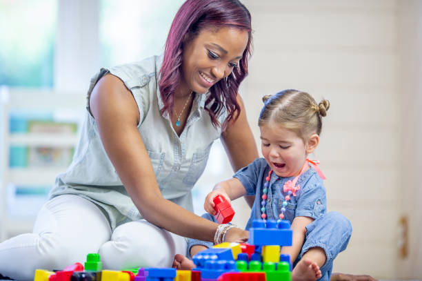 istock Daycare Provider Playing with a Toddler 1453837325