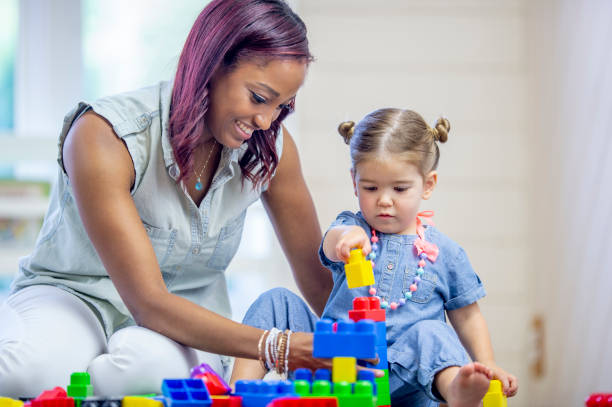 istock Daycare Provider Playing with a Toddler 1453837329
