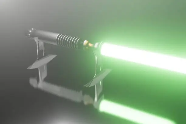 A lightsaber with a green light in a dark room