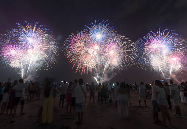 istock Fireworks on the beach. People watching the fireworks. The new year celebration. 1453839871