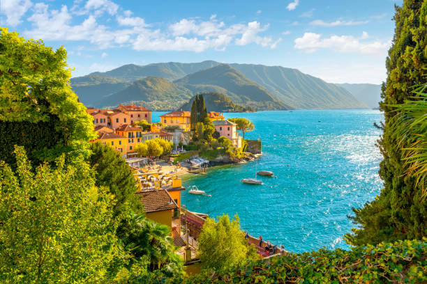 View from a hillside path looking down on the colorful picturesque village of Varenna, Italy, on the shores of Lake Como at summer. View from a hillside path looking down on the colorful picturesque village of Varenna, Italy, on the shores of Lake Como at summer. lake como stock pictures, royalty-free photos & images