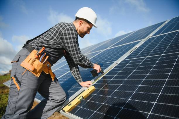 istock Men technicians installing photovoltaic solar moduls. Concept of alternative and renewable energy. 1453841050