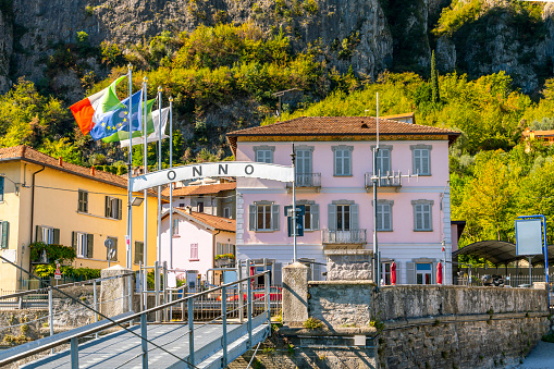 The ferry dock at the lakefront village of Onno, Italy, in the municipality of Oliveto Lario and province of Lecco on the shores of Lake Como. Lake Como, in Northern Italy’s Lombardy region, is an upscale resort area known for its dramatic scenery, set against the foothills of the Alps.