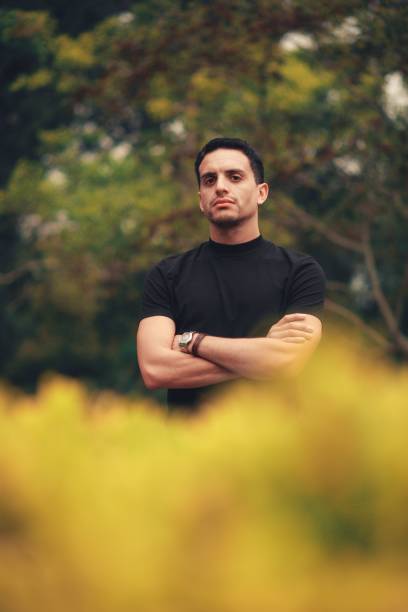 istock Vertical shot of a handsome Hispanic young man posing in the park. 1453842441