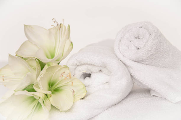 Towels rolled with candles and colored stones on a granite base
