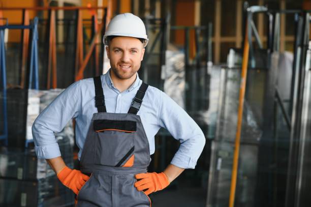 istock Factory for aluminum and PVC windows and doors production. Manual worker assembling PVC windows and doors 1453842653