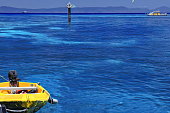 Yellow dinghy-starboard beacon-tourist pontoon-hydrographic survey vessel seen from Green Island jetty. Queensland-Australia-377