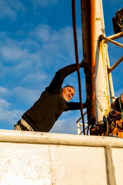 istock Middle-aged man playing captain on a boat stranded on an Icelandic beach 1453845158