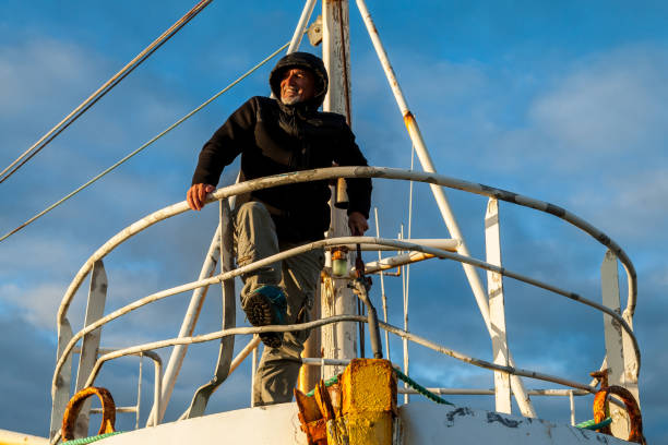 istock Middle-aged man playing captain on a boat stranded on an Icelandic beach 1453845162