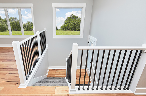 Modern wooden stairs and white walls, view from above
