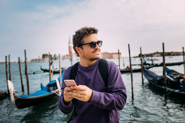 istock Student texting with his smart phone on street 1453848643
