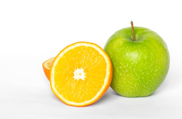 istock Green apple and orange on a white background isolated. 1453848748