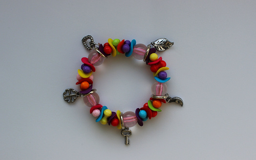 Multi-colored beads and silver charms in one wrist bracelet