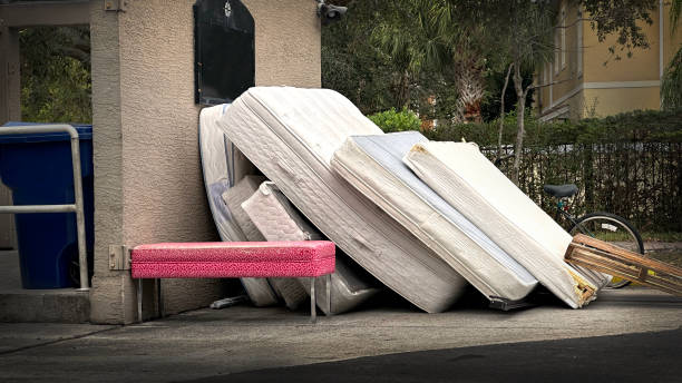 Furniture and mattresses at garbage dump area stock photo
