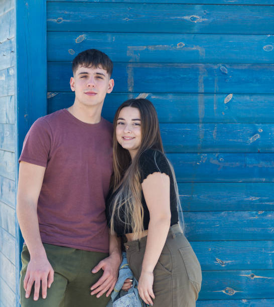 istock young heterosexual couple, vertical exterior image with deep blue background. 1453851755