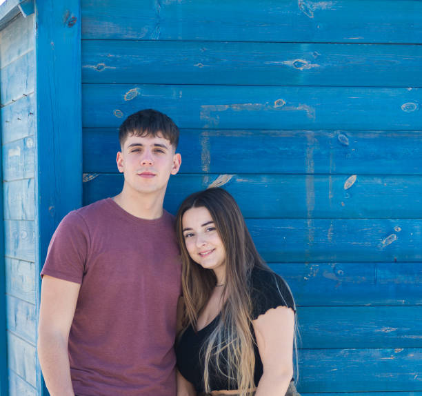 istock young heterosexual couple, vertical exterior image with deep blue background. 1453851758
