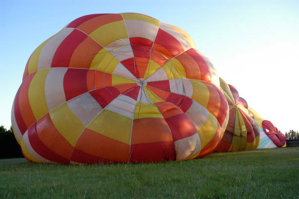 istock Hot air balloon inflating over the grass. 1453852233