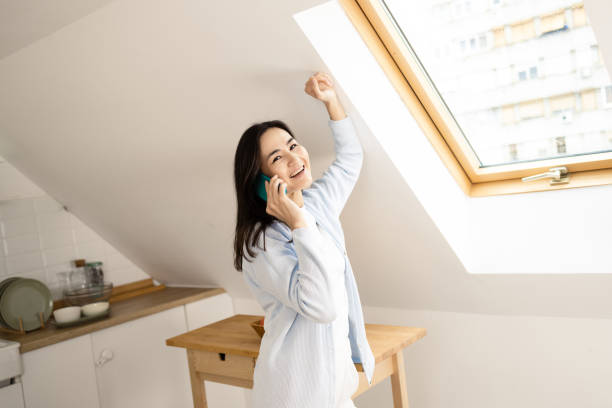 istock Happy woman chatting on mobile phone at home 1453854429