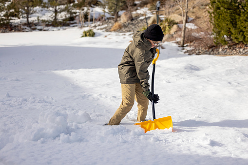 High quality stock photos of a boy doing chores, shoveling snow at home after a snow storm