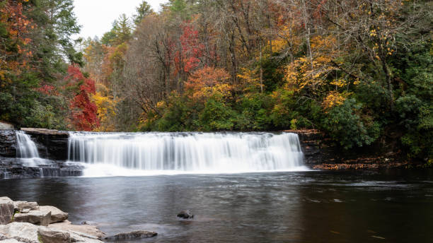 istock Refreshing Waterfall Hidden Deep in the Autumn Forest 1453858097