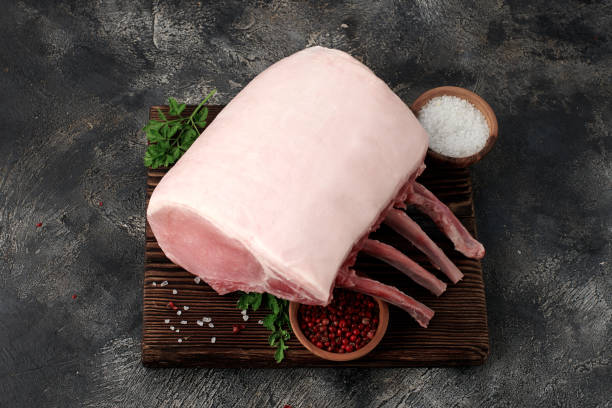 Raw fresh pork rack on wooden board stock photo